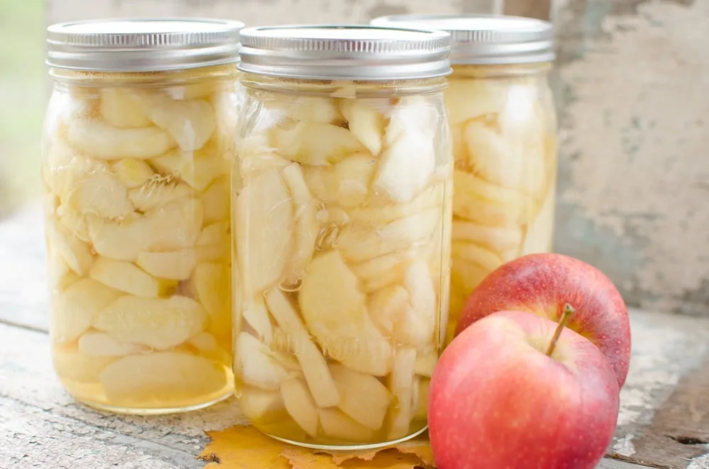 How To Can Crisp Apple Slices glass jars of apples on counter table