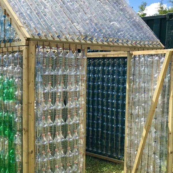 a mini greenhouse built with recycled bottles
